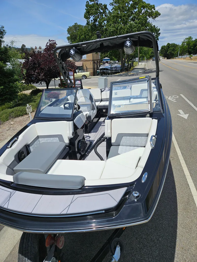 Slide: The Image of 2023 HEYDAY WAKE BOATS H20 on trailer, sleek design, spacious interior, parked roadside. - 9