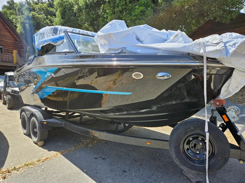 Slide: The Image of 2023 HEYDAY WAKE BOATS H20 on trailer, partially covered, outdoors. - 14