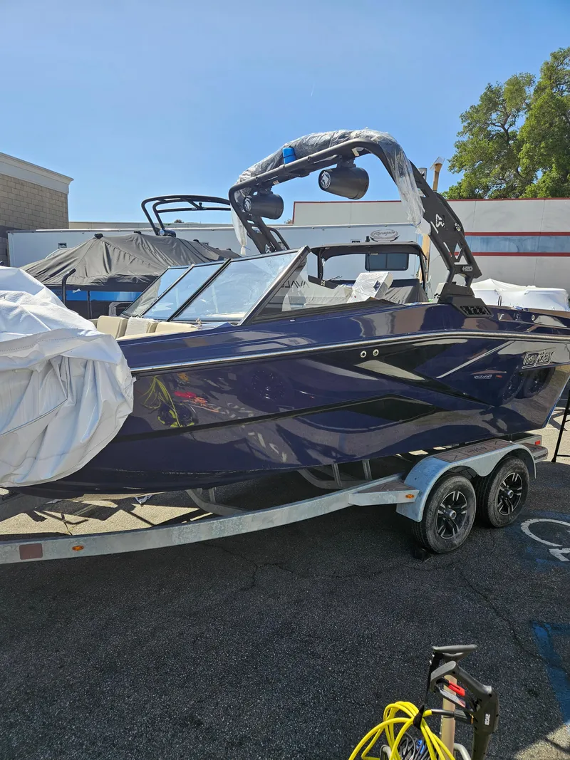Slide: The Image of 2023 HEYDAY WAKE BOATS H20 on trailer, parked outdoors under clear sky. - 15