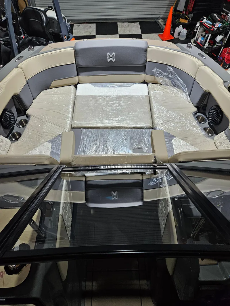 Slide: The Image of 2023 HEYDAY WAKE BOATS H20 interior with beige and gray seating, wrapped in plastic. - 7