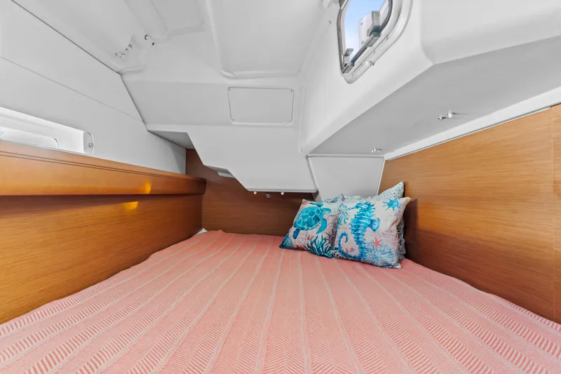 Slide: The Image of Cozy cabin interior of 2020 Jeanneau Sun Odyssey 389 with decorative pillows and wooden accents. - 12