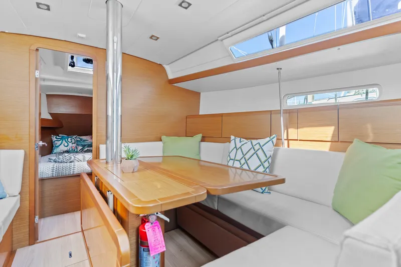 Slide: The Image of Interior of 2020 Jeanneau Sun Odyssey 389 sailboat with cozy seating and dining area. - 18