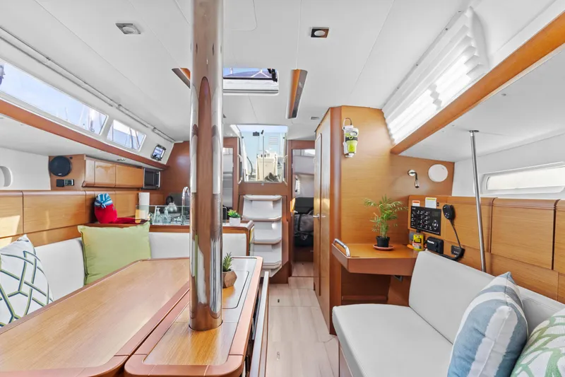 Slide: The Image of Interior of 2020 Jeanneau Sun Odyssey 389 sailboat, featuring modern wood finish and cozy seating. - 19