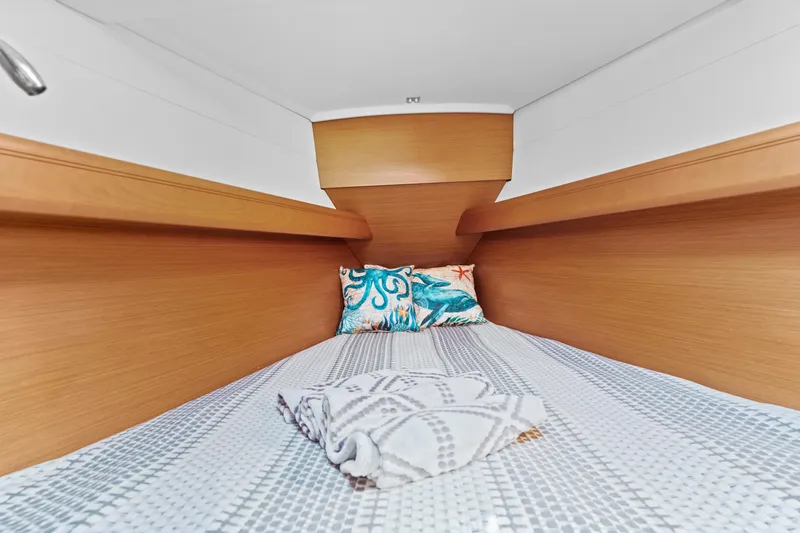 Slide: The Image of Cozy cabin interior of 2020 Jeanneau Sun Odyssey 389 sailboat with bedding and pillow. - 21
