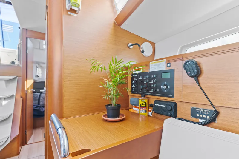 Slide: The Image of Jeanneau Sun Odyssey 389 interior, 2020 model, featuring navigation panel and potted plant. - 23