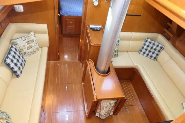 Slide: The Image of Interior of 2002 Tayana 460 Vancouver Pilothouse with cozy seating and wooden finishes. - 14