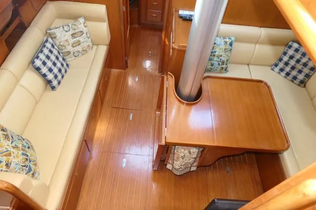 Slide: The Image of Interior of 2002 Tayana 460 Vancouver Pilothouse with wooden flooring and cushioned seating. - 15