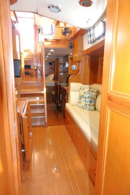 Slide: The Image of Interior of 2002 Tayana 460 Vancouver Pilothouse with wooden finish and cozy seating area. - 22