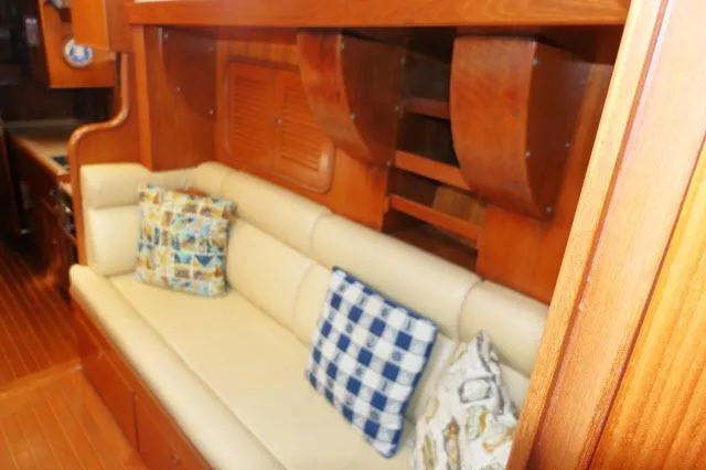 Slide: The Image of Interior of 2002 Tayana 460 Vancouver Pilothouse with beige sofa and decorative pillows. - 23