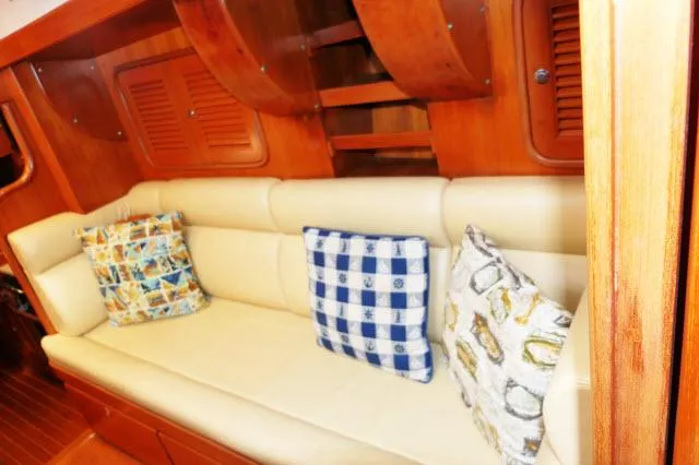 Slide: The Image of Interior of 2002 Tayana 460 Vancouver Pilothouse with cushioned seating and decorative pillows. - 24