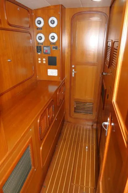 Slide: The Image of 2002 Tayana 460 Vancouver Pilothouse interior with wood paneling and control gauges. - 28