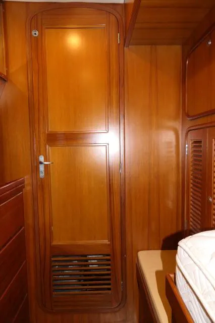 Slide: The Image of Wooden interior of 2002 Tayana 460 Vancouver Pilothouse, featuring a door and storage. - 41