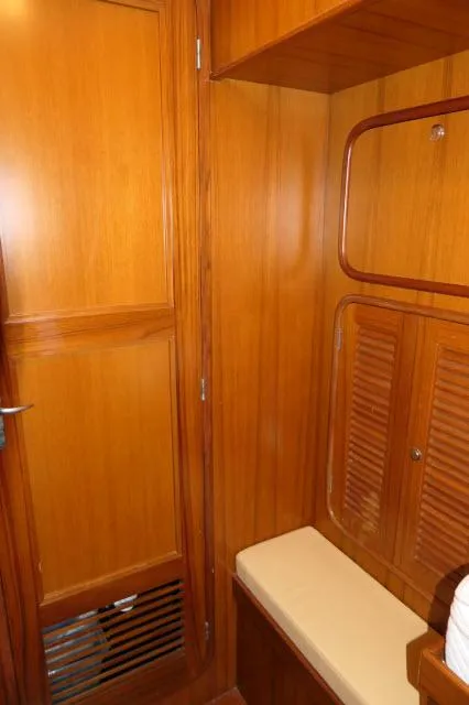 Slide: The Image of Interior of 2002 Tayana 460 Vancouver Pilothouse with wooden cabinetry and cushioned seating. - 42