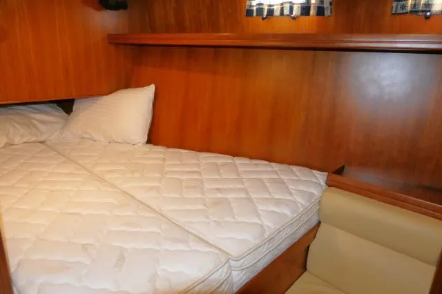 Slide: The Image of Cozy cabin interior of 2002 Tayana 460 Vancouver Pilothouse with wooden finish and comfortable bedding. - 44