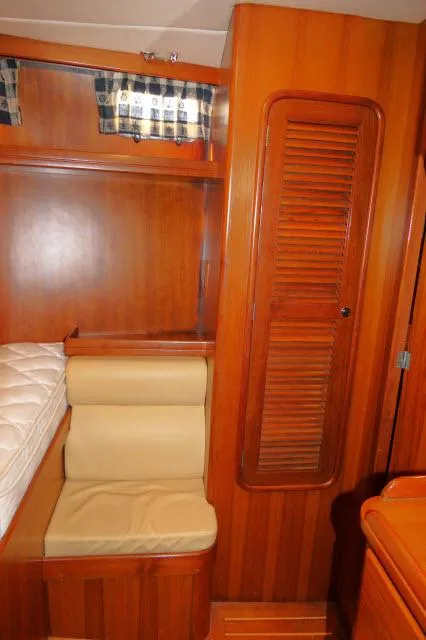 Slide: The Image of 2002 Tayana 460 Vancouver Pilothouse interior with wooden cabinetry and seating. - 45