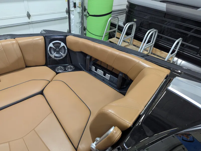 Slide: The Image of 2021 Malibu Wakesetter 24 MXZ interior with tan leather seating and speaker system. - 11