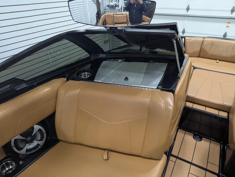 Slide: The Image of 2021 Malibu Wakesetter 24 MXZ interior with tan leather seats and sleek design. - 13
