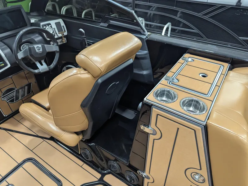 Slide: The Image of 2021 Malibu Wakesetter 24 MXZ interior with tan leather seats and modern dashboard. - 17