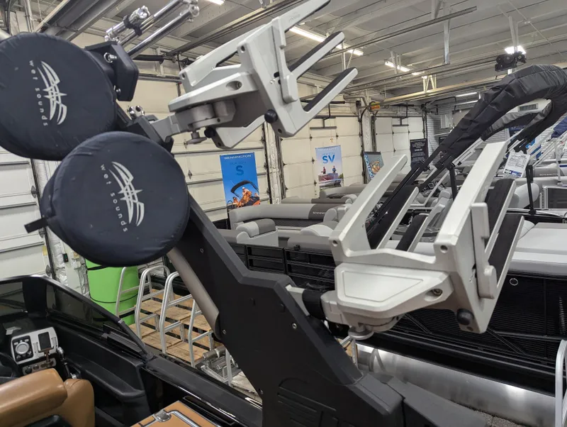 Slide: The Image of 2021 Malibu Wakesetter 24 MXZ boat with wakeboard racks in a showroom. - 19