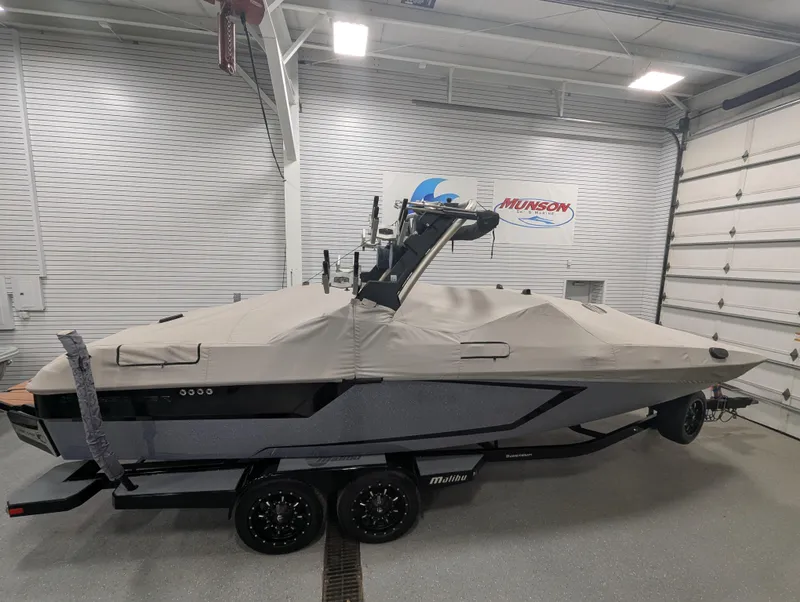 Slide: The Image of 2021 Malibu Wakesetter 24 MXZ boat covered in a garage setting. - 23