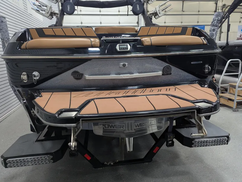 Slide: The Image of 2021 Malibu Wakesetter 24 MXZ boat rear view in a garage setting. - 3