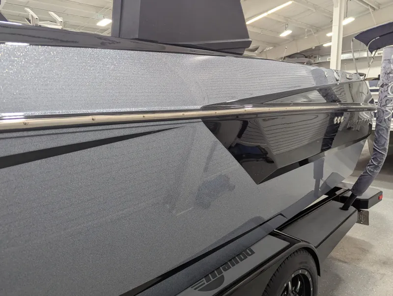 Slide: The Image of 2021 Malibu Wakesetter 24 MXZ boat side view in showroom setting. - 5