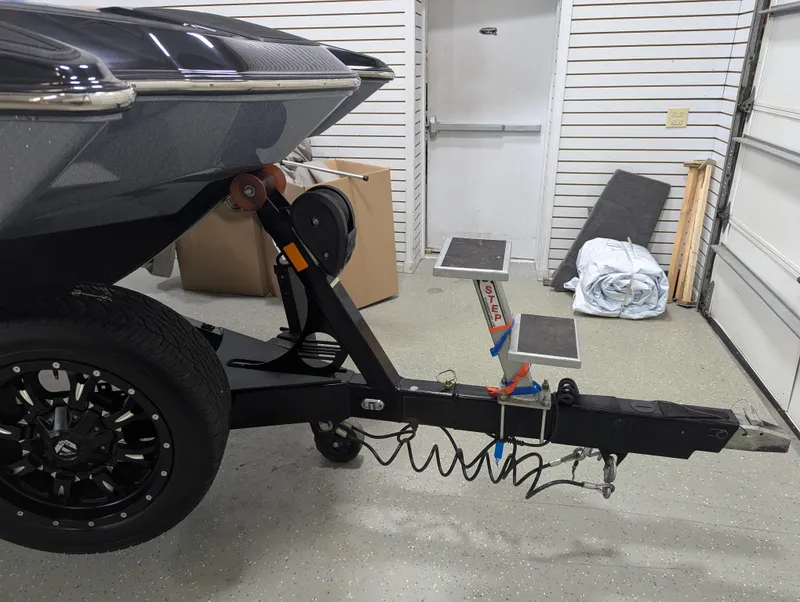 Slide: The Image of 2021 Malibu Wakesetter 24 MXZ trailer hitch in a garage setting. - 7