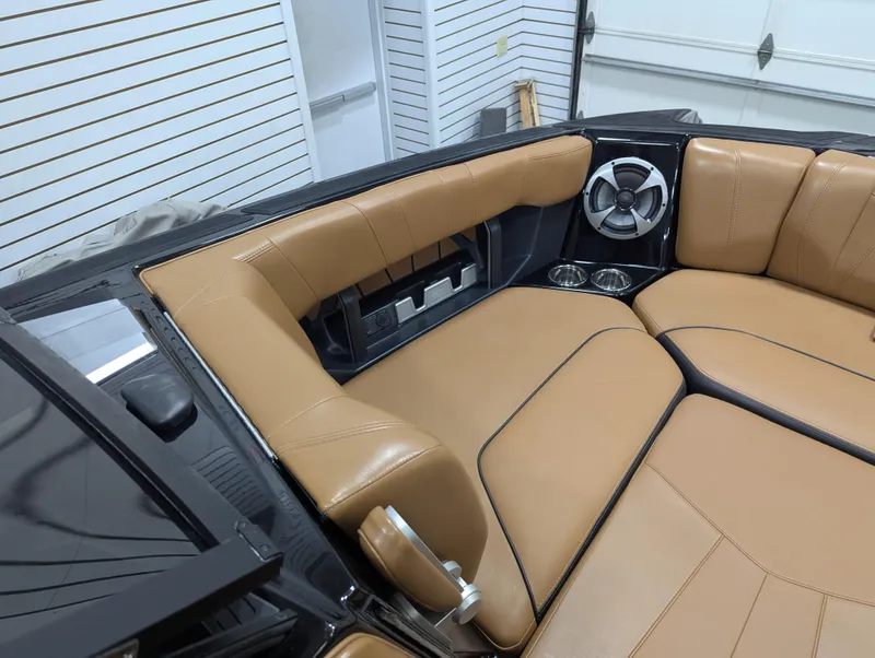 Slide: The Image of 2021 Malibu Wakesetter 24 MXZ interior with tan leather seating and speaker system. - 8