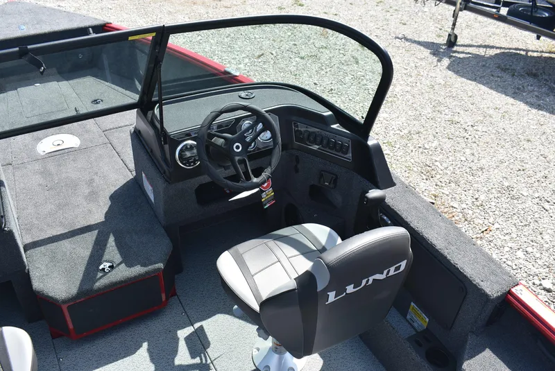 Slide: The Image of 2025 Lund 1775 Impact XS Sport boat interior with steering wheel and seating. - 10