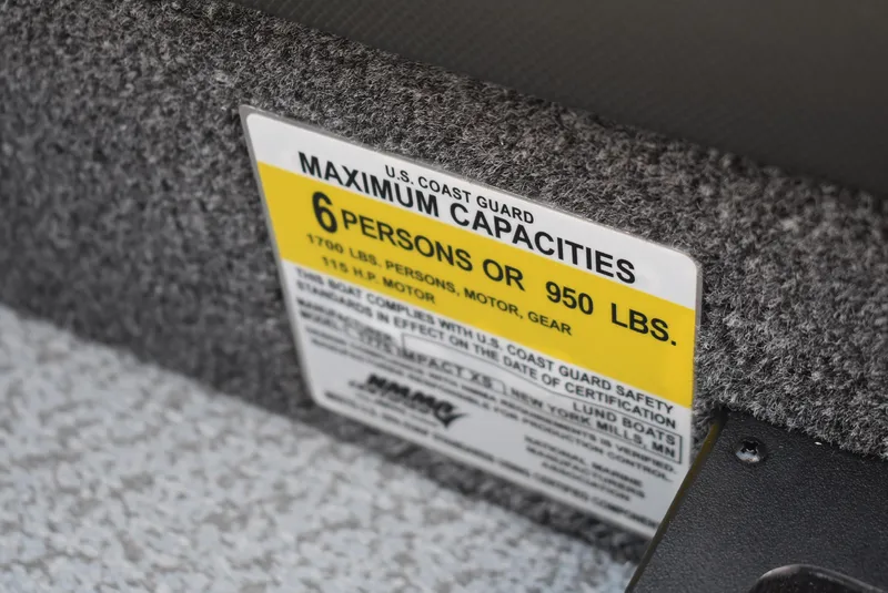 Slide: The Image of 2025 Lund 1775 Impact XS Sport capacity label, 6 persons or 950 lbs, U.S. Coast Guard certified. - 11