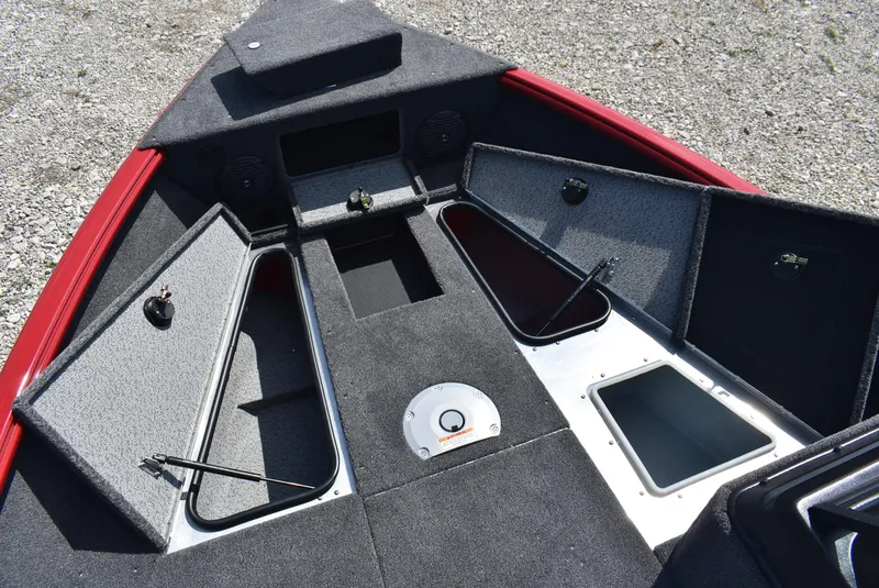 Slide: The Image of 2025 Lund 1775 Impact XS Sport boat interior with open storage compartments. - 14