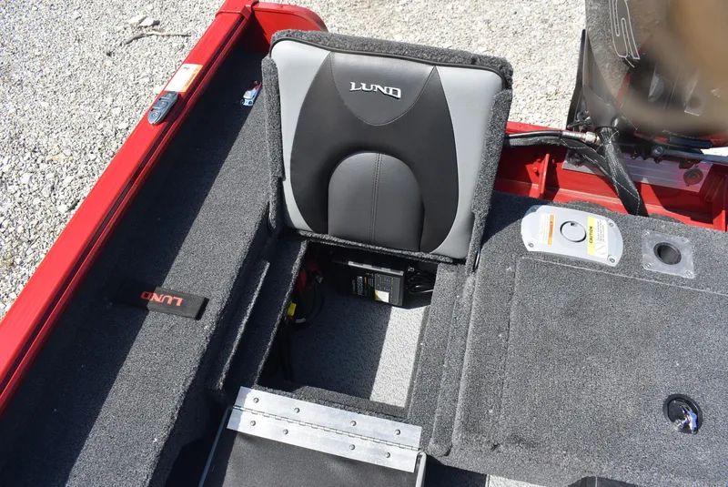 Slide: The Image of 2025 Lund 1775 Impact XS Sport boat interior with seat and storage compartments. - 16