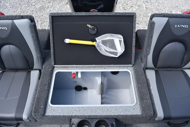 Slide: The Image of 2025 Lund 1775 Impact XS Sport boat interior with storage compartment and fishing net. - 17