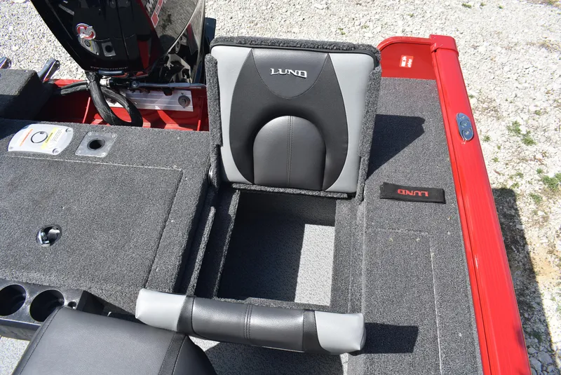 Slide: The Image of 2025 Lund 1775 Impact XS Sport boat interior with gray seating and red accents. - 18