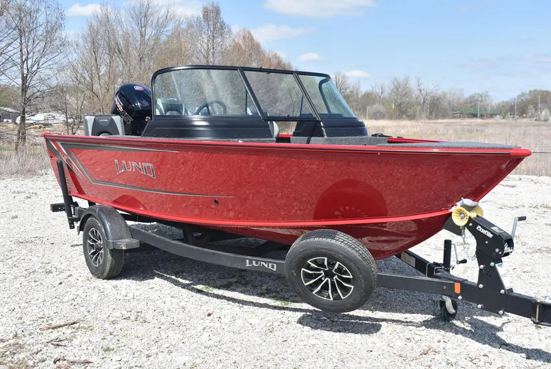 Slide: The Image of 2025 Lund 1775 Impact XS Sport boat on trailer, red exterior, parked outdoors. - 3