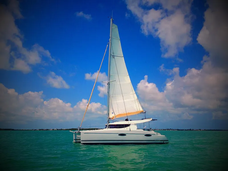 The Image of 2014 Fountaine Pajot Mahe 36 Evolution sailing on turquoise waters under a blue sky. - 0