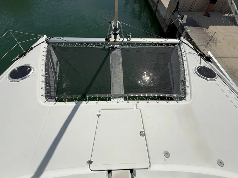 Slide: The Image of 2014 Fountaine Pajot Mahe 36 Evolution catamaran deck with netting and hatches. - 14