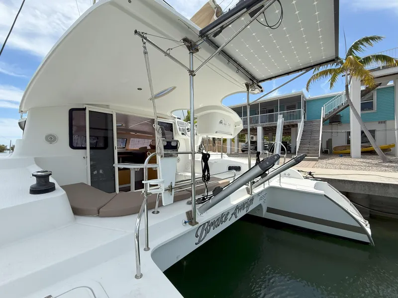 Slide: The Image of 2014 Fountaine Pajot Mahe 36 Evolution catamaran docked, featuring spacious deck and modern design. - 18