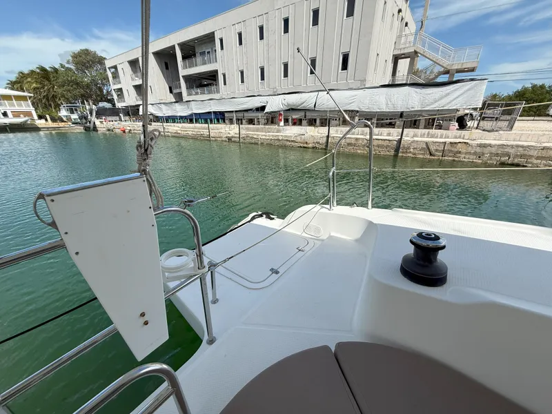 Slide: The Image of 2014 Fountaine Pajot Mahe 36 Evolution yacht docked by a modern building. - 20