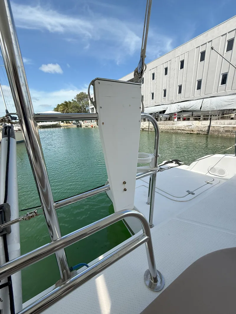 Slide: The Image of 2014 Fountaine Pajot Mahe 36 Evolution yacht docked, showcasing deck and railing. - 21