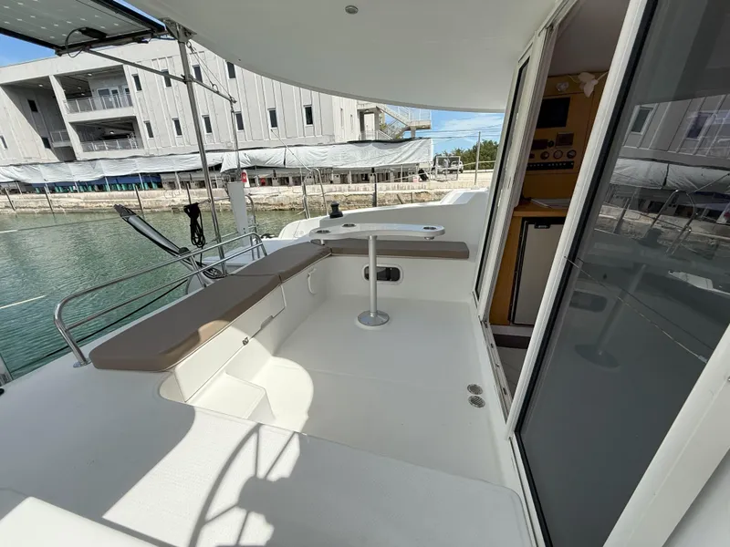 Slide: The Image of 2014 Fountaine Pajot Mahe 36 Evolution yacht deck with seating and table. - 24
