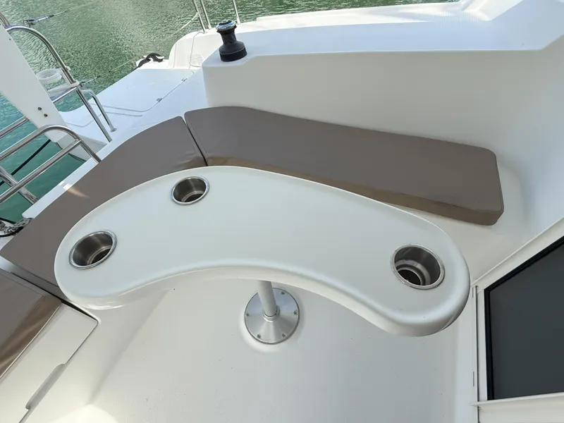 Slide: The Image of 2014 Fountaine Pajot Mahe 36 Evolution yacht seating area with curved table and cup holders. - 27