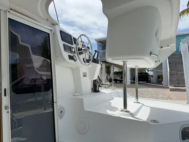 Slide: The Image of 2014 Fountaine Pajot Mahe 36 Evolution cockpit with steering wheel and navigation controls. - 33