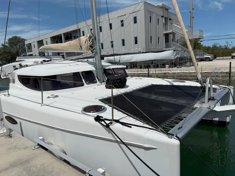 Slide: The Image of 2014 Fountaine Pajot Mahe 36 Evolution catamaran docked, featuring sleek design and spacious deck. - 4