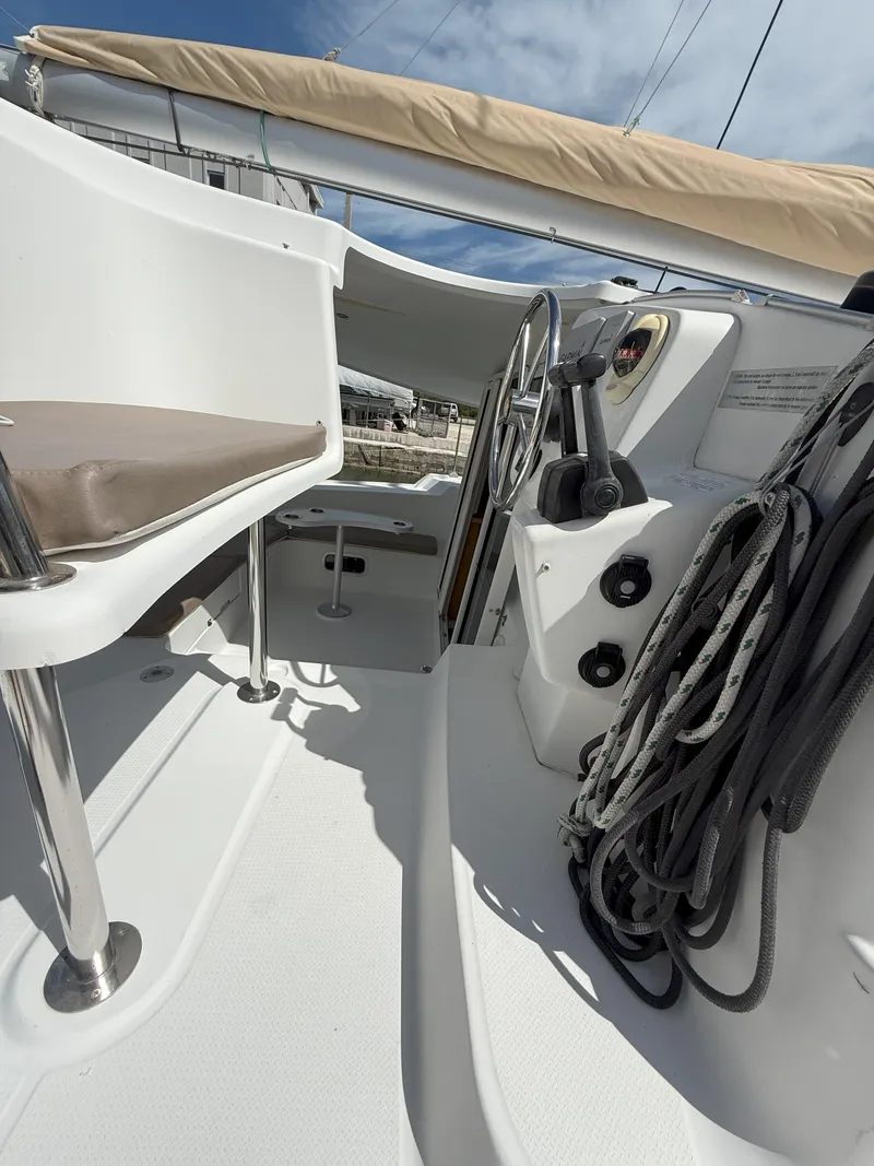 Slide: The Image of 2014 Fountaine Pajot Mahe 36 Evolution yacht cockpit with steering wheel and ropes. - 43