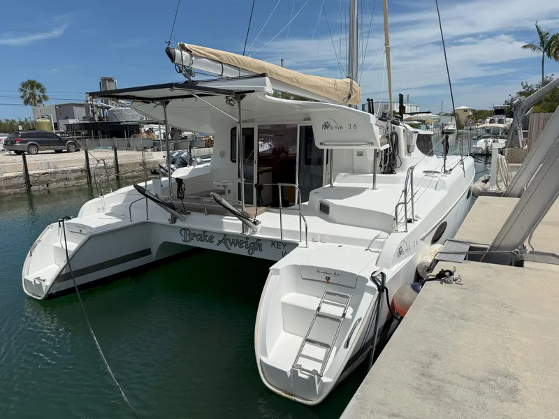 Slide: The Image of 2014 Fountaine Pajot Mahe 36 Evolution catamaran docked in a marina. - 6