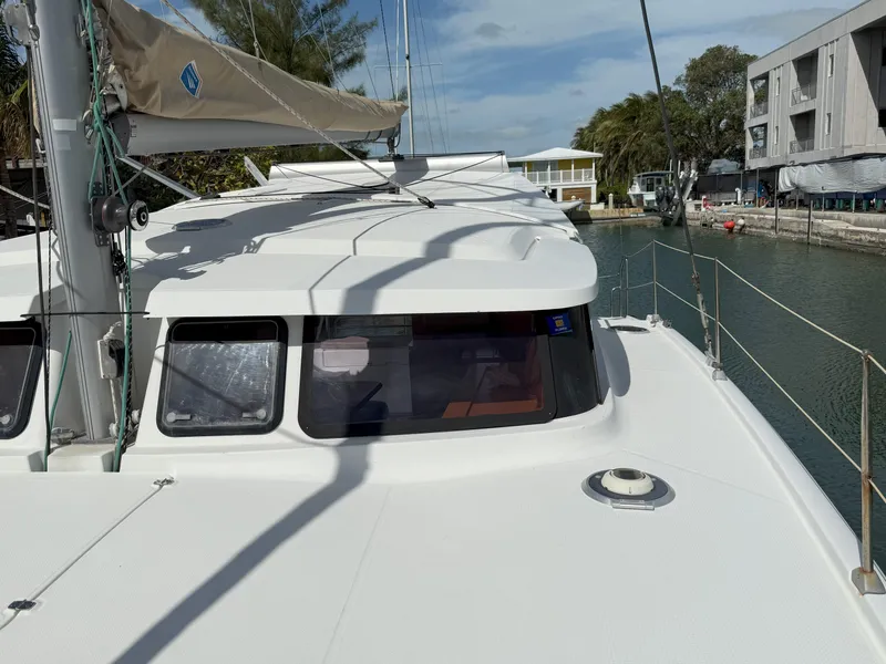 Slide: The Image of 2014 Fountaine Pajot Mahe 36 Evolution catamaran docked, showcasing sleek design and spacious deck. - 10