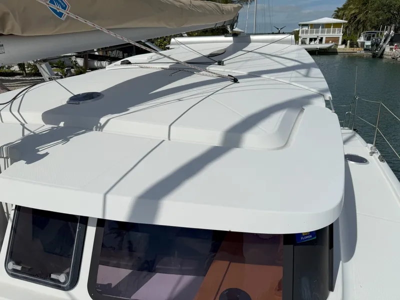 Slide: The Image of 2014 Fountaine Pajot Mahe 36 Evolution catamaran, docked, top view of deck and sail. - 11
