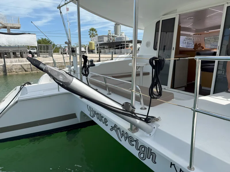 Slide: The Image of 2014 Fountaine Pajot Mahe 36 Evolution catamaran docked, featuring spacious deck and modern design. - 17