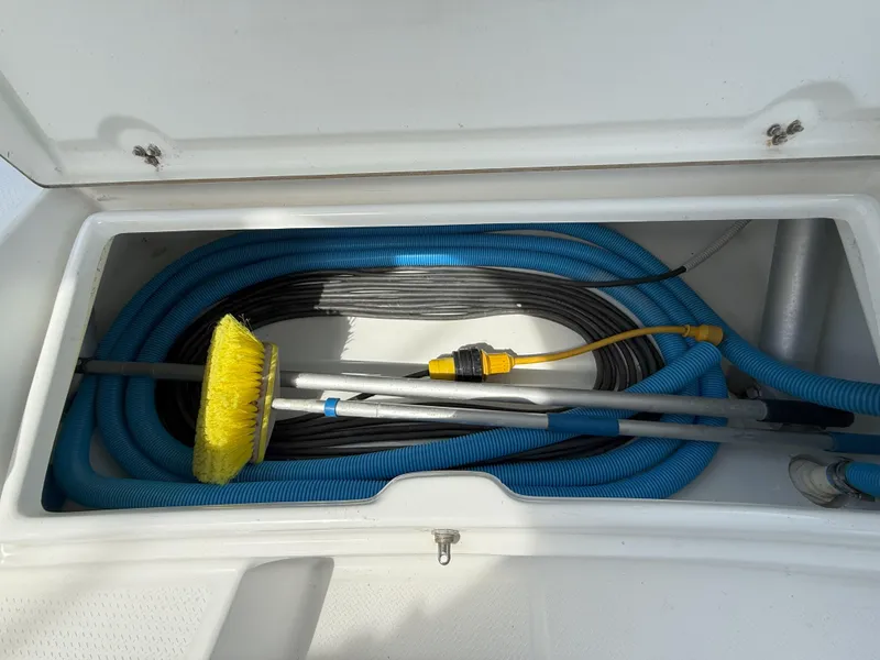 Slide: The Image of Storage compartment with hoses and cleaning tools on a 2014 Fountaine Pajot Mahe 36 Evolution. - 28